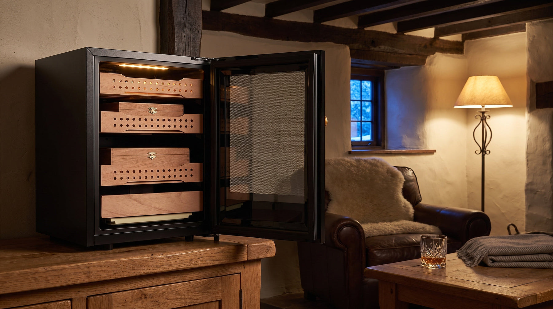 Afidano B1 compact cigar humidor open on an oak sideboard in an alpine chalet snug, Spanish cedar trays inside