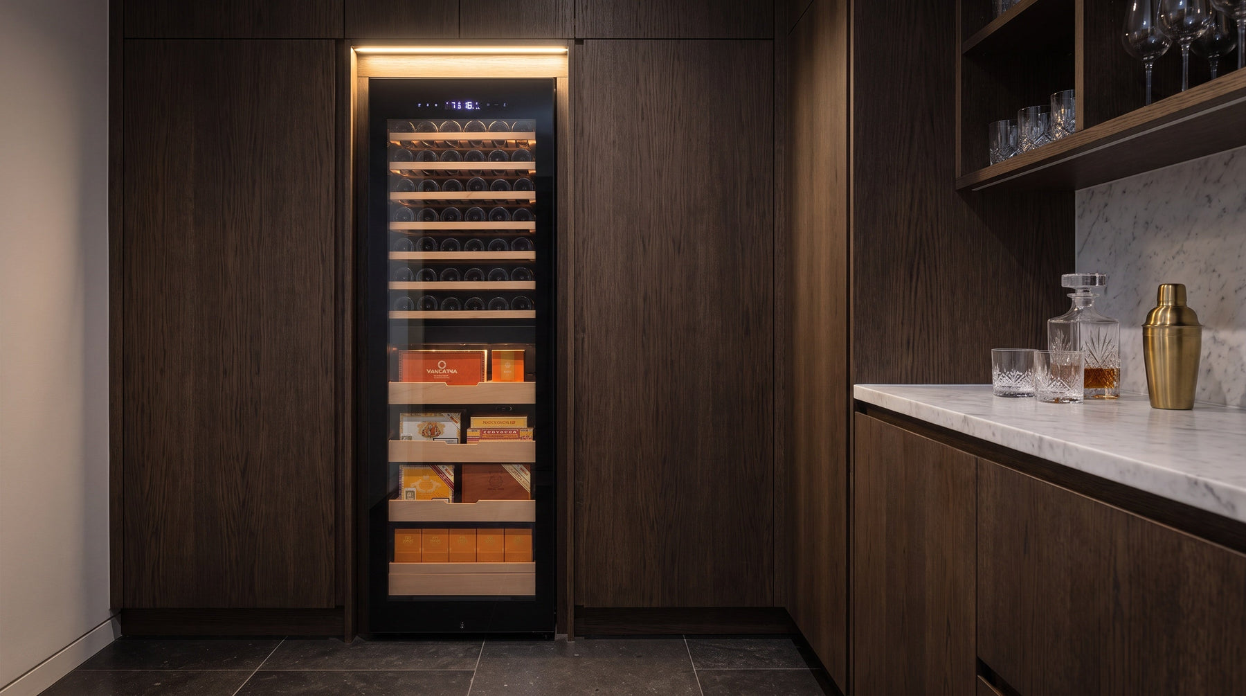 Afidano dual-zone cigar and wine cabinet recessed flush into dark oak joinery in a butler's pantry bar