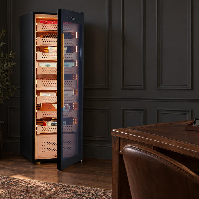 Afidano B8 cigar humidor cabinet open to its lit cedar trays, with hygrometers on a walnut desk