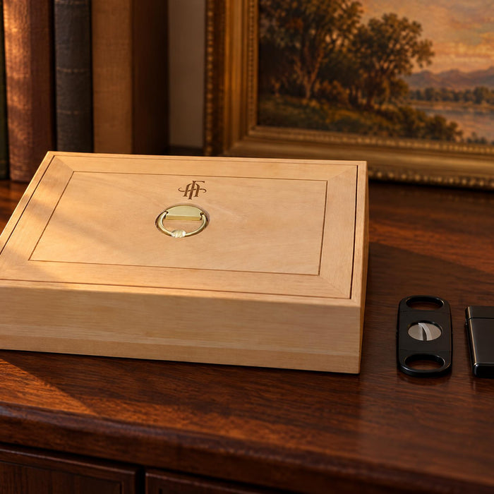 Afidano Spanish cedar cigar box with brass ring pull on a walnut sideboard in golden evening light