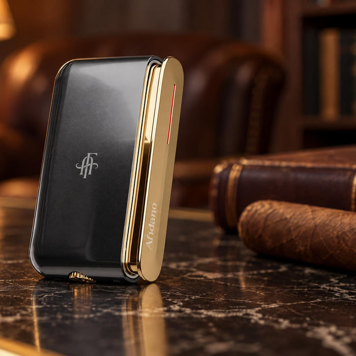 Afidano luxury jet flame cigar lighter in black and gold standing on a marble desk in a lamplit lounge