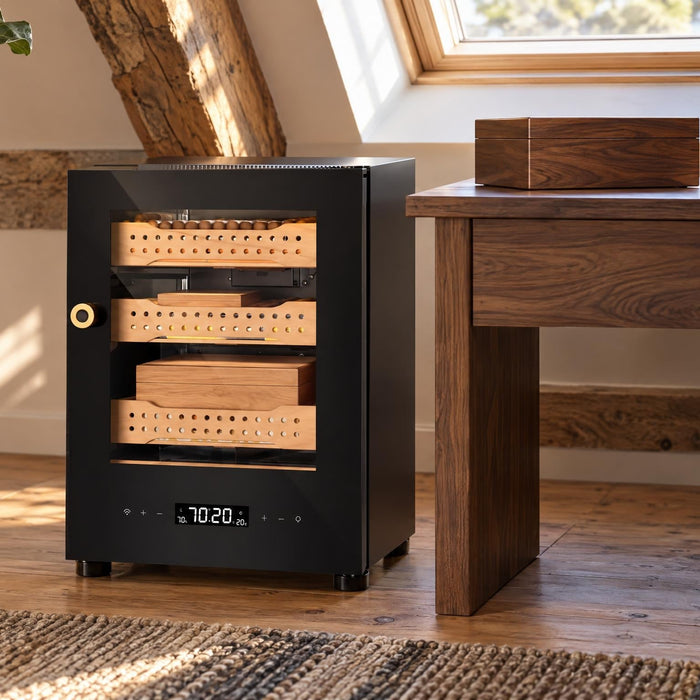 Afidano B1 electronic cigar humidor beside a desk holding a traditional wooden humidor box in a loft office