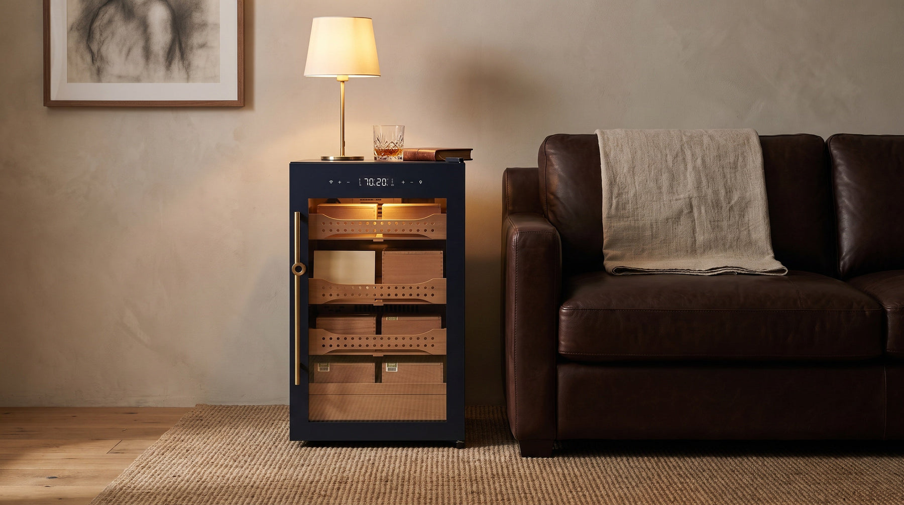 Afidano B2 cigar humidor cabinet used as an end table beside a leather sofa, brass lamp standing on its top