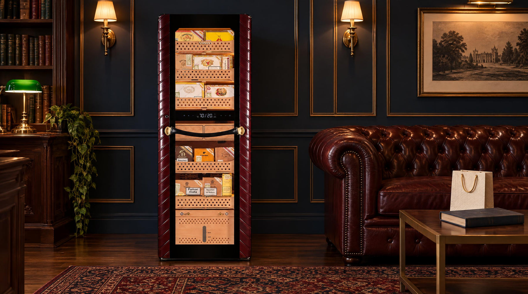 Afidano C8 2500-count cigar humidor cabinet in a navy-paneled lounge with a Chesterfield sofa and gift bag
