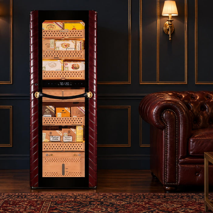 Afidano C8 2500-count cigar humidor cabinet in a navy-paneled lounge with a Chesterfield sofa and gift bag