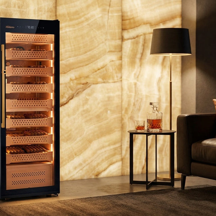 Afidano B8 glass door cigar humidor lit against an onyx wall, Spanish cedar trays stacked with cigars inside