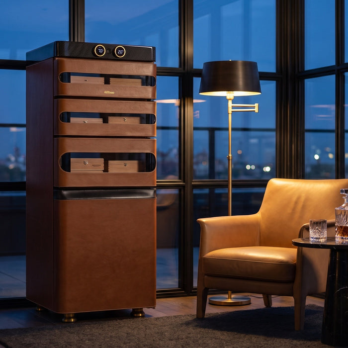 Afidano L5 Artistry leather cigar humidor with twin gold dials in a glass rooftop lounge at dusk over city lights