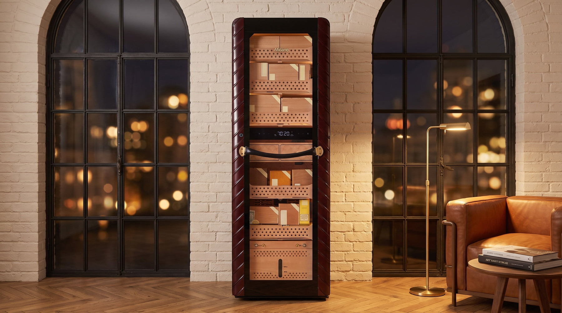 Afidano C8 tower cigar humidor in ribbed oxblood leather between arched windows of a city apartment at night